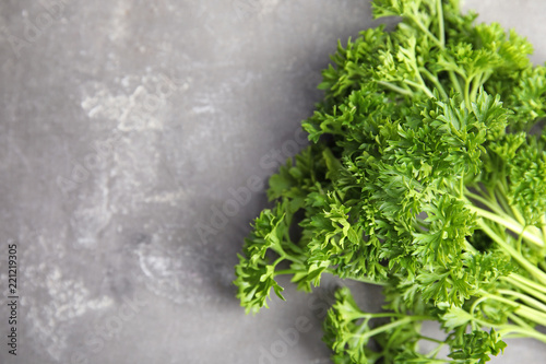 Fresh green parsley and space for text on grey background, closeup