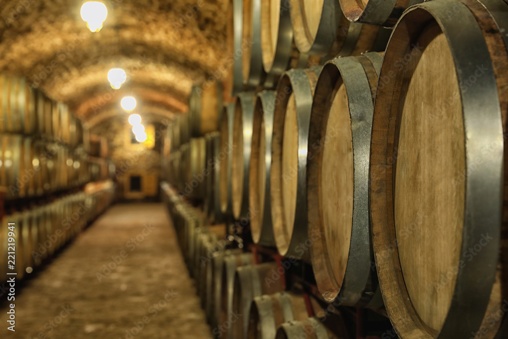 Large wooden barrels in wine cellar, closeup