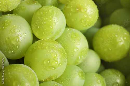 Bunch of green fresh ripe juicy grapes as background, closeup