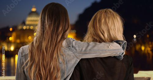 Photography Young brunette with arm around blonde friend's shoulder in Rome, Italy