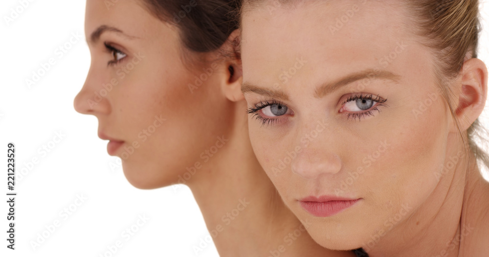Tight shot of model's face with make-up posing for camera on white copy space Tight shot of model's face with make-up posing for camera on white copy space