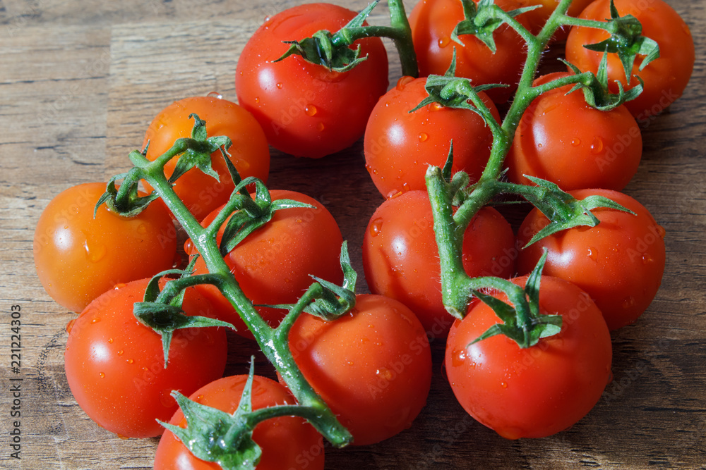 Cherry tomatoes on a wooden table with natural light.