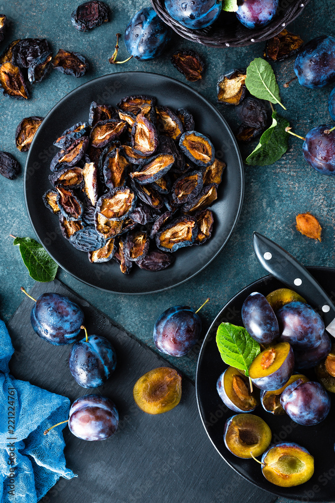 Fototapeta premium Dried prune and fresh plums with leaves