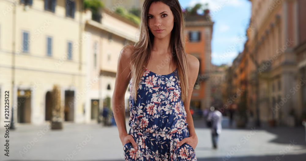 Stylish attractive woman in her 20s posing casually outdoors in street in Rome