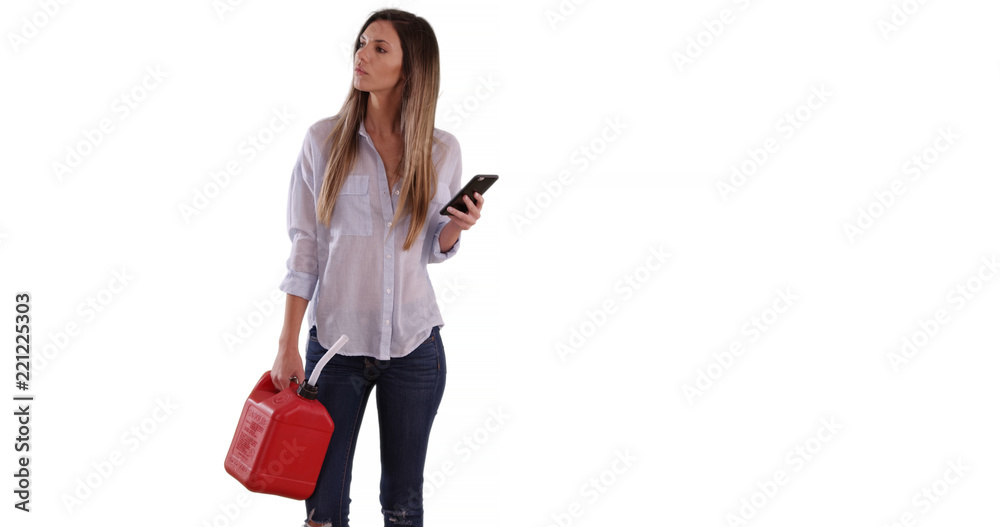 Lost female holding gas can getting directions on phone on white copy space Lost female holding gas can getting directions on phone on white copy space