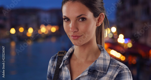 Beautiful millennial girl in her 20s looking at camera by Grand Canal in Venice © rocketclips
