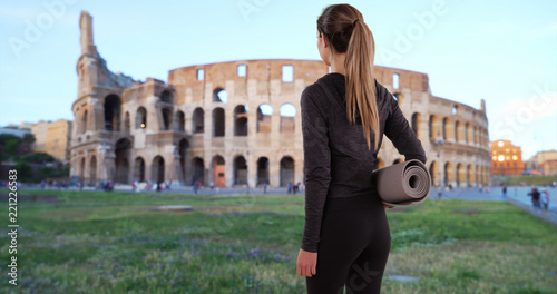 Photography Yoga girl in workout attire facing away from camera nearby Colosseum in Rome