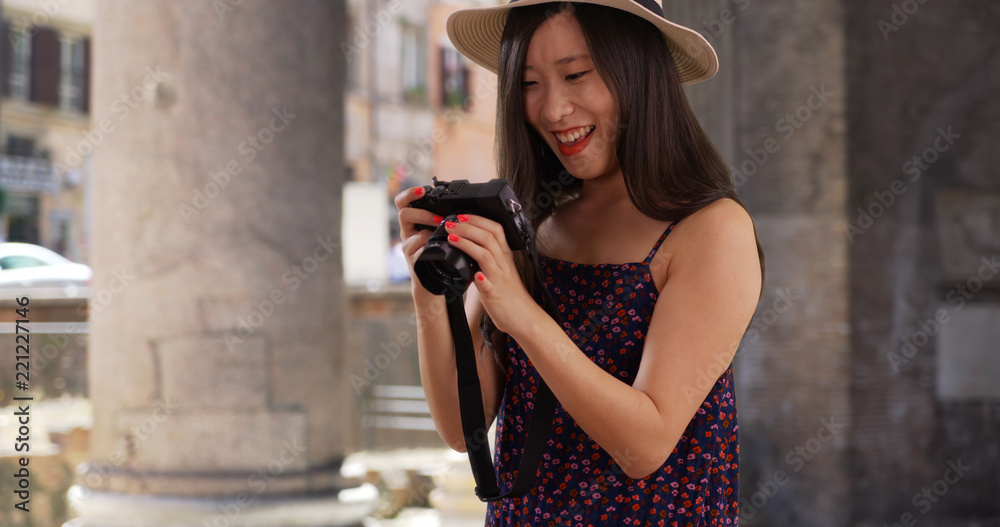 Obraz premium Closeup of Asian millennial photographer taking pictures in Rome Italy
