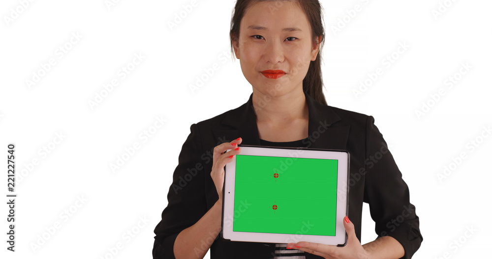 Smiling business lady holding handheld tablet with green chromakey for copyspace Smiling business lady holding handheld tablet with green chromakey for copyspace