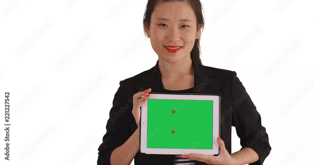 Smiling business lady holding handheld tablet with green chromakey for copyspace Smiling business lady holding handheld tablet with green chromakey for copyspace