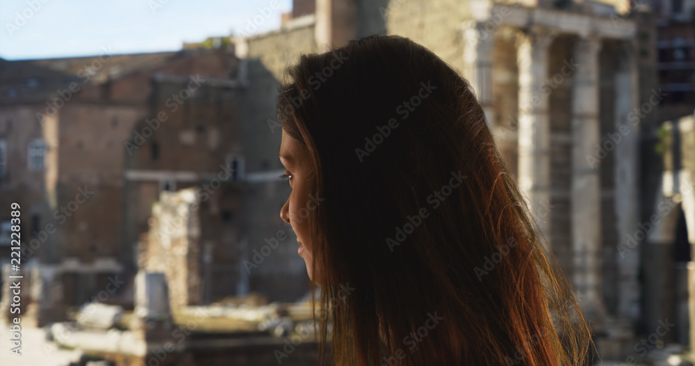 Side view of pretty tourist woman in Italy visiting the Roman Forum