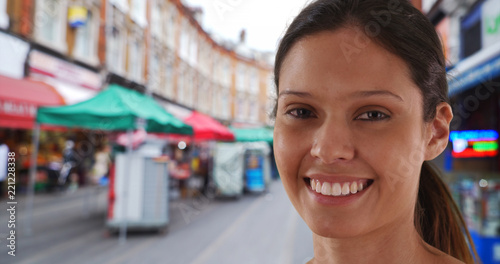 Portrait of cheerful female at Brixton market sightseeing and exploring London photo