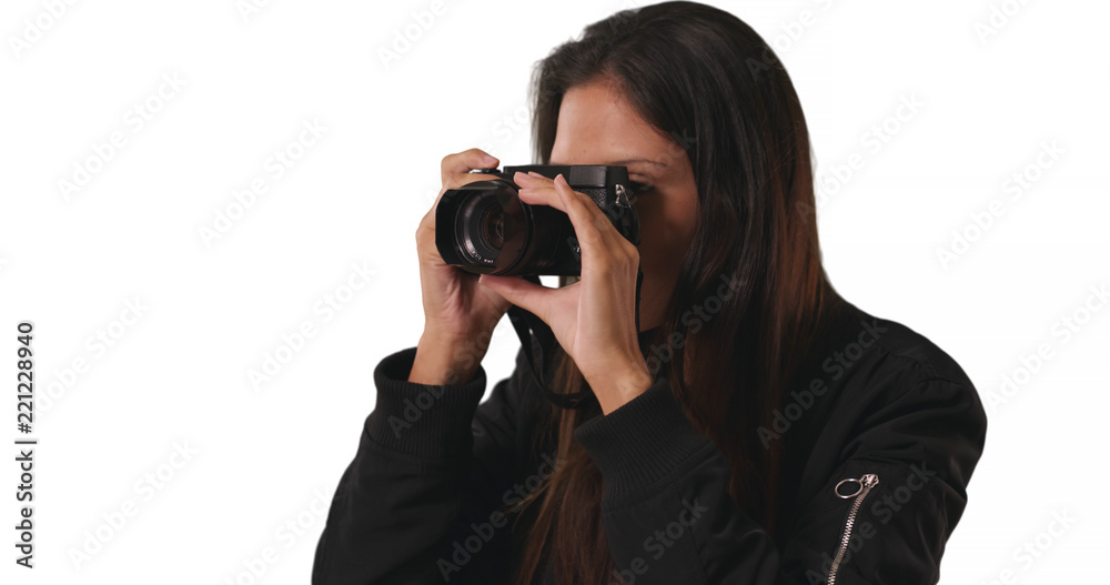 Closeup of hipster girl in bomber jacket taking photo with dslr camera in studio Closeup of hipster girl in bomber jacket taking photo with dslr camera in studio
