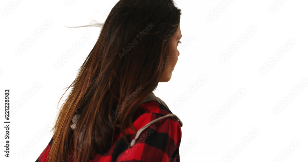 Rear view of hipster girl in flannel jacket looking away from camera in studio Rear view of hipster girl in flannel jacket looking away from camera in studio