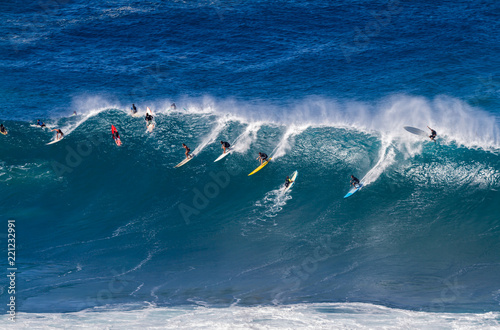 Surfers riding a wave in Hawaii