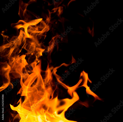 Flame of fire with sparks on a black background © donikz