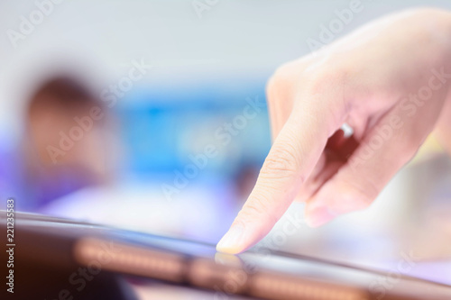 Hand touch on tablet on blur background