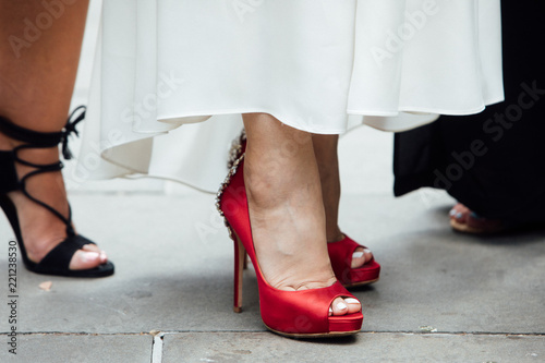 A bride's red high-heeled shoes during an urban city wedding