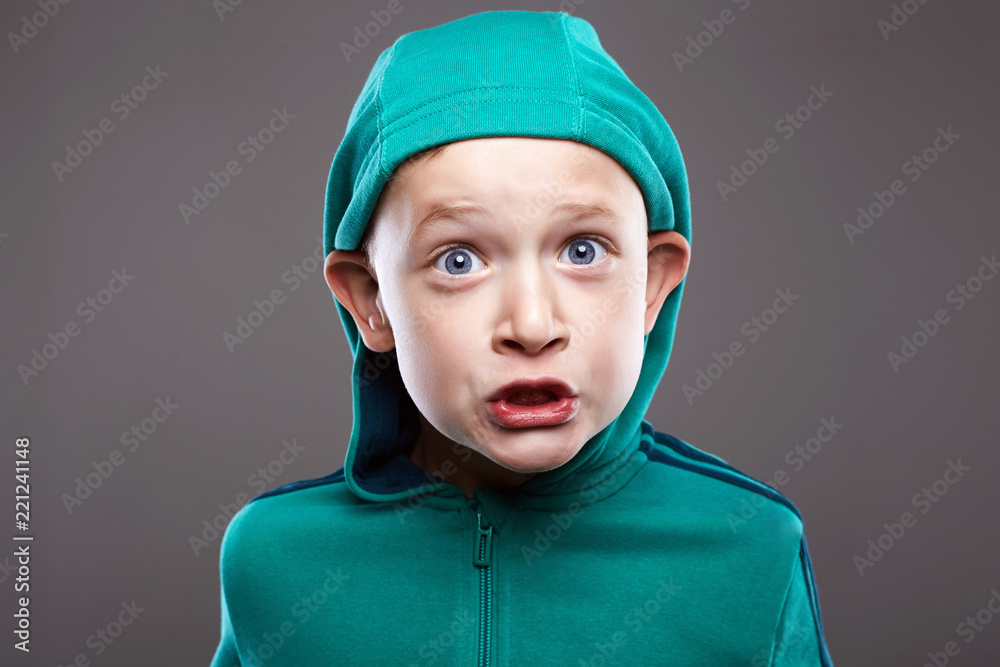 Funny boy in Hood. grimaced emotion child