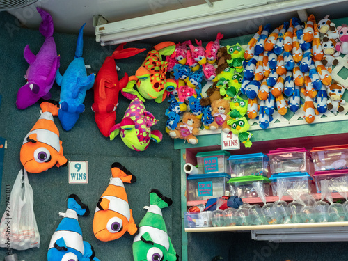 Various live and stuffed fish prizes at a carnival game