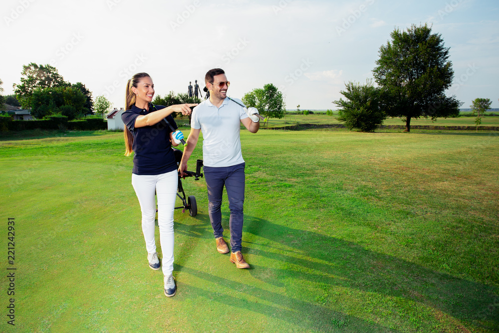 Young couple enjoying time on a golf course