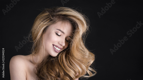 Portrait of a beautiful woman on black Background. Perfect Skin and hair concept. Beauty Face
