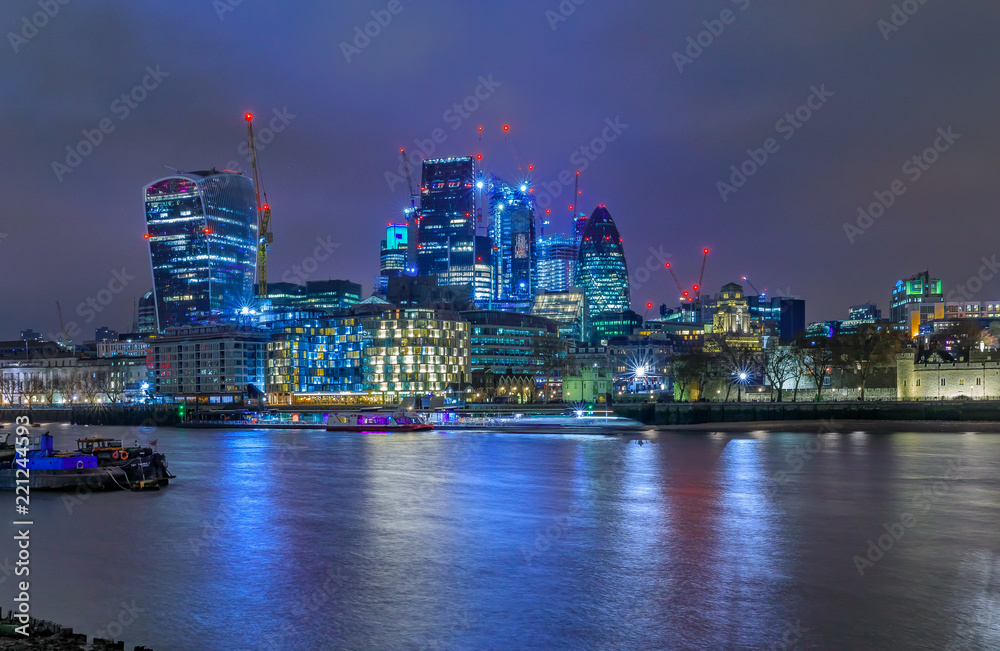 Obraz premium London city skyline at night with skyscrapers against cloudy skies in England UK
