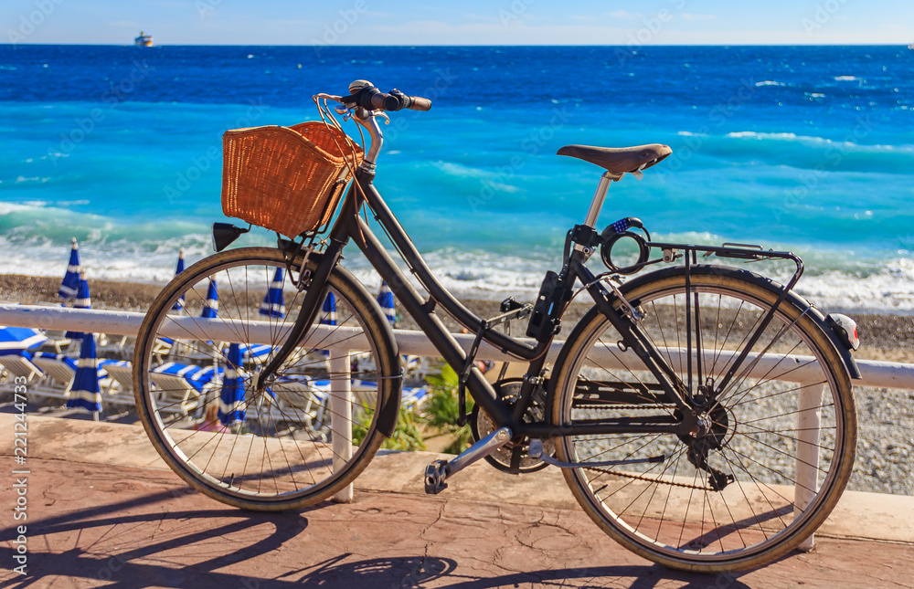 Fototapeta premium Bicycle on Promenade des Anglais with the Mediterranean sea in the background in Nice France