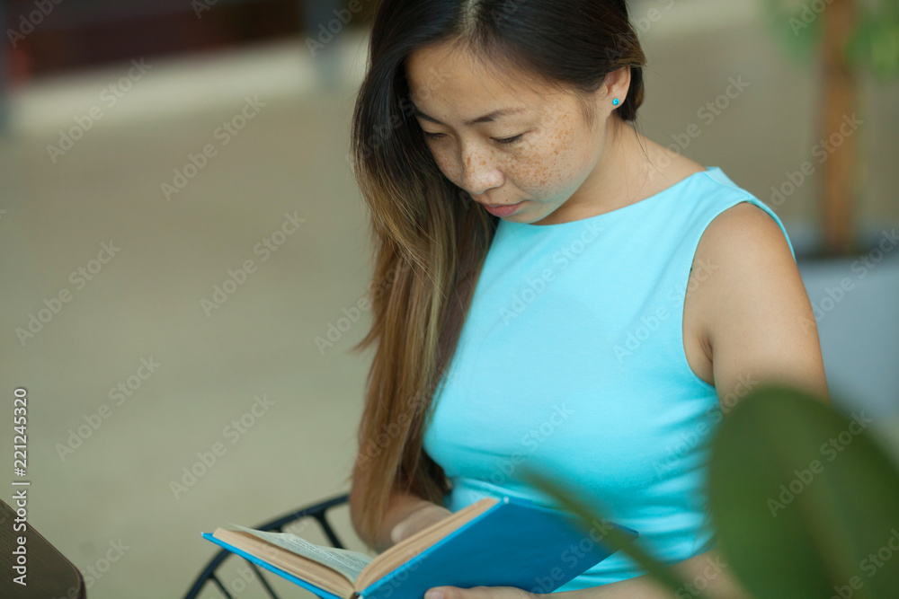beautiful young asian woman reading a book in cafe beautiful young asian woman reading a book in cafe
