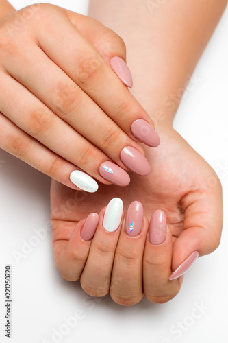 gently pink manicure with white pearly rub on long oval nails with crystals  rhombuses on a white background  