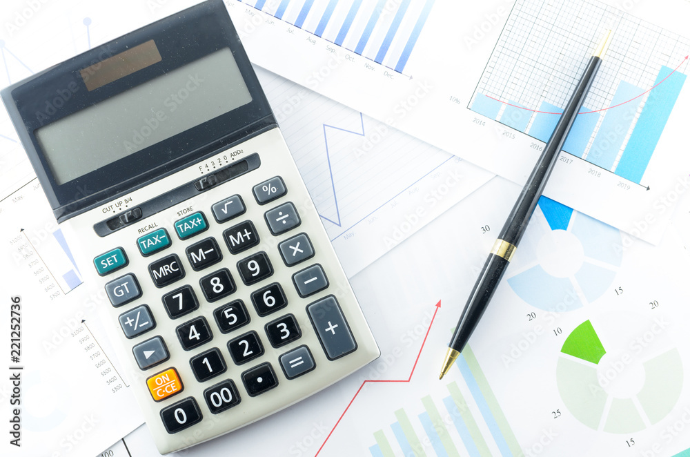 Calculator and Pen with Business Graphs finance document. Calculator and Pen with Business Graphs finance document.