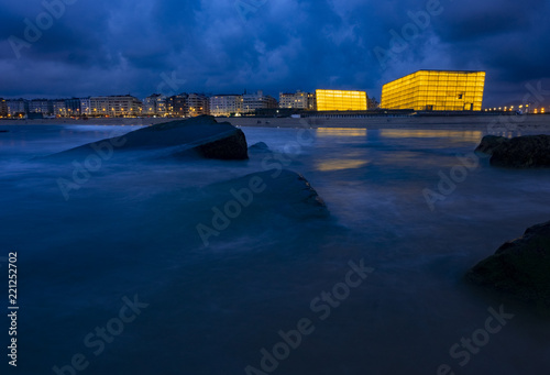 SAN SEBASTIAN, SPAIN - SEPTEMBER 5, 2018: Iluminates Palacio de Congresos-Auditorio Kursaal next to the beach of Zurriola an anocher in the city of San Sebastian photo