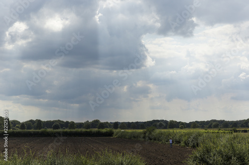 Man Using Metal Detector In Field