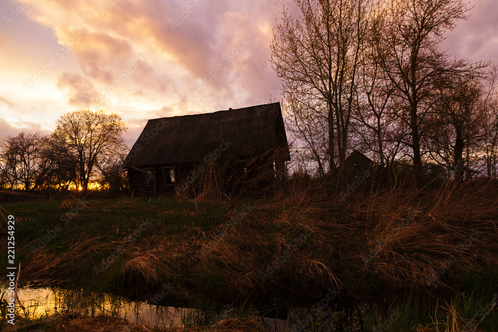Old house in the Russian village at sunset Old house in the Russian village at sunset