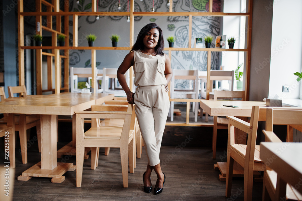 Stylish african american girl posed at modern cafe. Stylish african american girl posed at modern cafe.