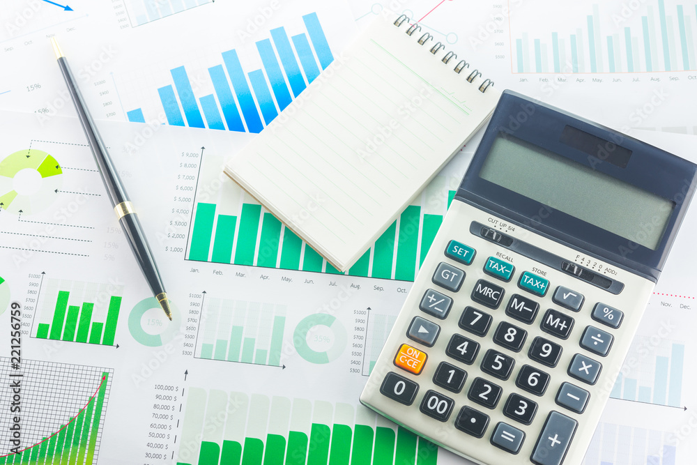 Calculator and Pen with Business Graphs finance document. Calculator and Pen with Business Graphs finance document.