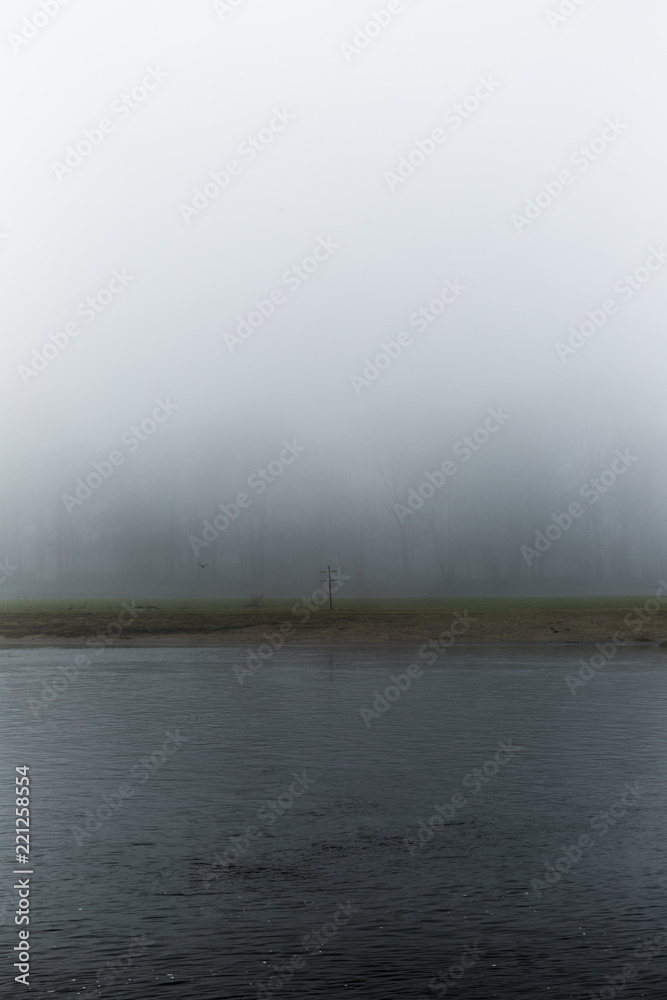Dark Gloomy Fog Landscape With Wooden Cross