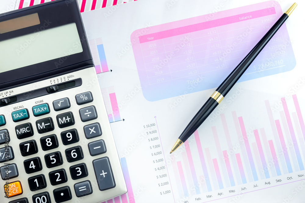 Calculator and Pen with Business Graphs finance document. Calculator and Pen with Business Graphs finance document.