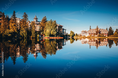 Luxury hotels by lake in mountains. Accommodation concept photo