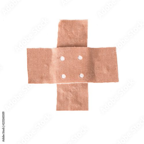 band-aid plaster in cross shape isolated on a white background, copy space
