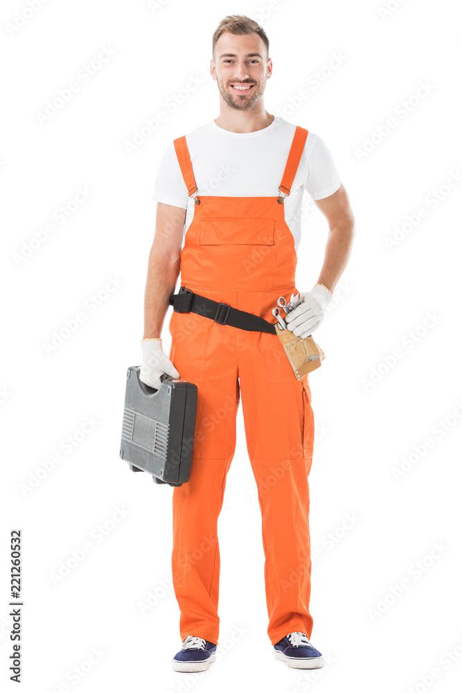 smiling handsome auto mechanic in orange uniform holding toolbox isolated on white smiling handsome auto mechanic in orange uniform holding toolbox isolated on white