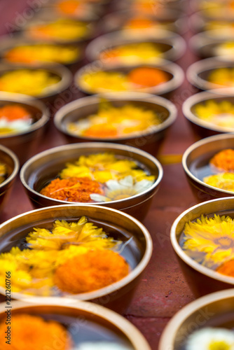 Buddhist flower offerings or gifts in bowls and rows