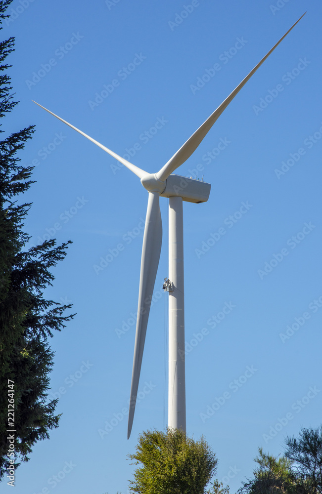 A man ,hanging in a nacelle, is doing maintenance on a wind turbine in south of France on August 2018 A man ,hanging in a nacelle, is doing maintenance on a wind turbine in south of France on August 2018