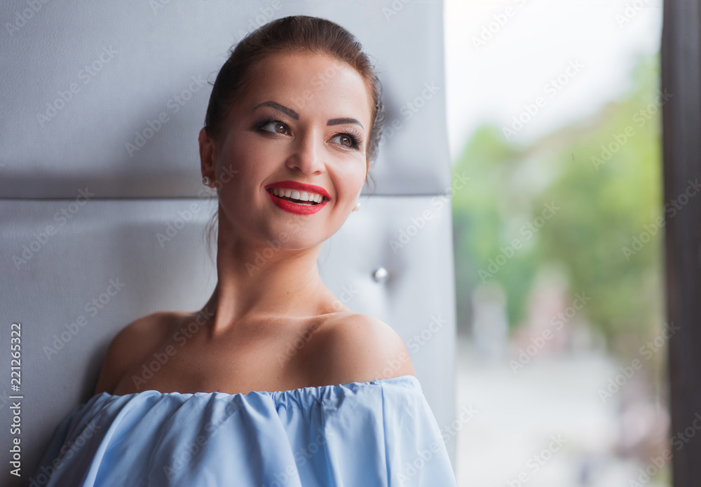Portrait of beautiful asian woman in blue dress in the cafe Portrait of beautiful asian woman in blue dress in the cafe