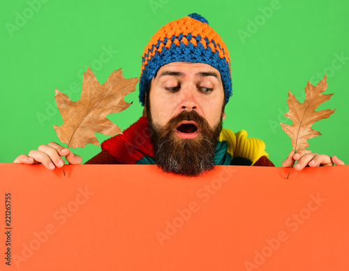 Hipster with beard and curious face looks down