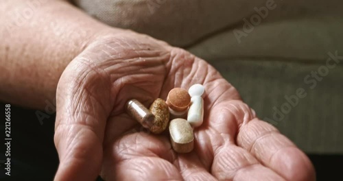 Many pills on senior woman palm. Closeup shot.