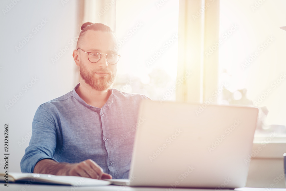 Young businessman working on laptop / Young man working on his desk. Young businessman working on laptop / Young man working on his desk.