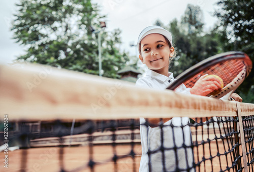 Εκτύπωση καμβά Happy little girl playing tennis. Summer sport