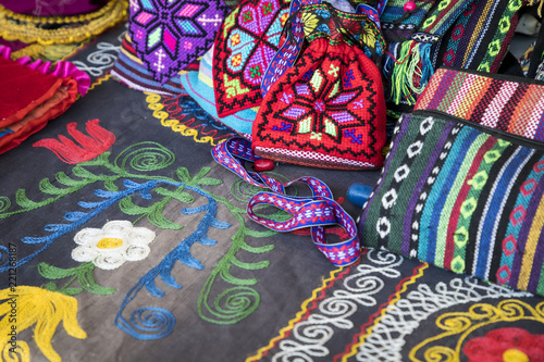 Market stalls with decorative tribal textile with colourful pattern made in Central Asia, Uzbekistan. © Curioso.Photography