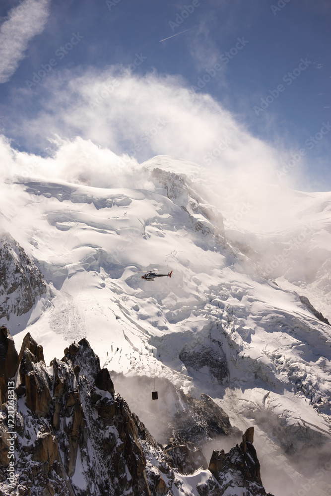 Helicopter flying in the Alps